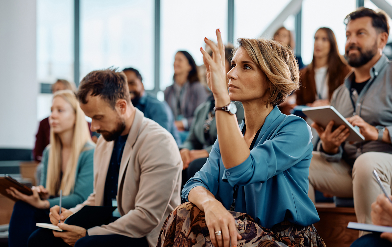 Une équipe diversifiée d’âges, de races, de genres et de capacités mixtes faisant face à la caméra.